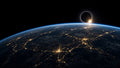 Earth at night with a diamond-ring eclipse