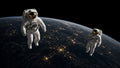 Two EVA crew above a nightside Earth limb.